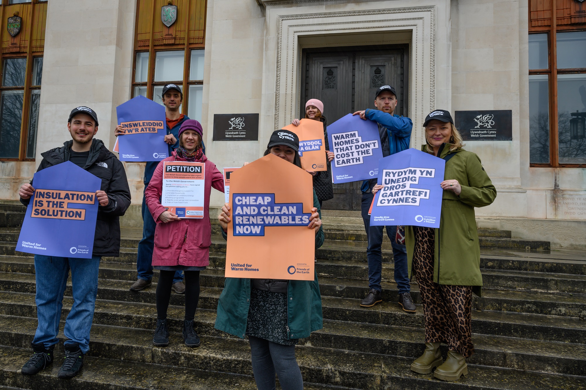 Campaigners holding up placards on steps