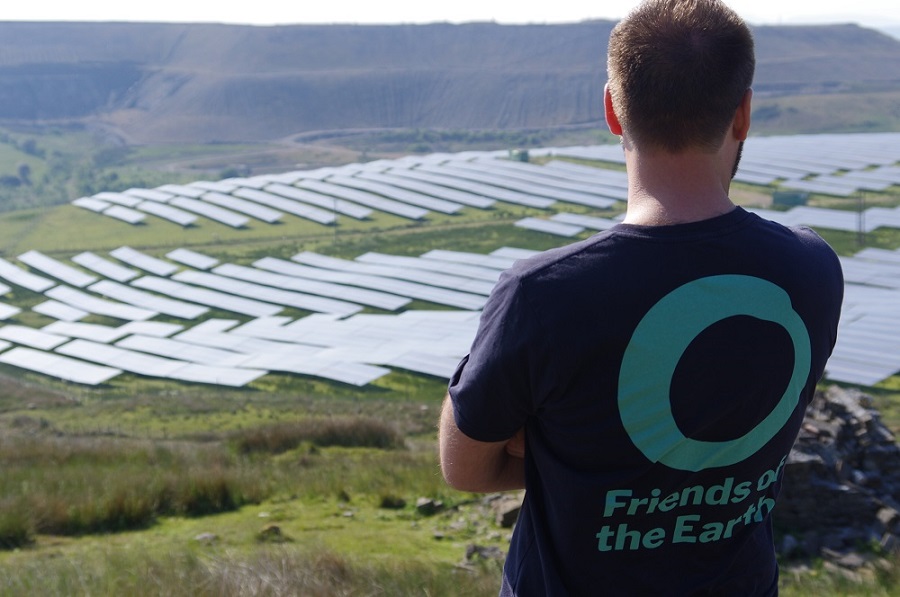 People standing looking at solar panels
