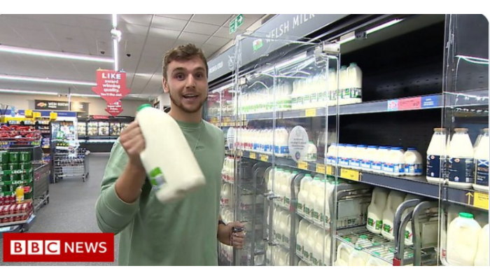 Picture of man opening a supermarket fridge door