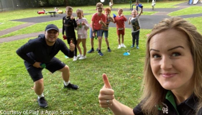 Photo of Play it Again sport staff in a field with kids