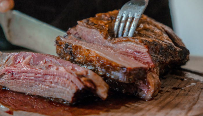 Picture of someone cutting a joint of meat