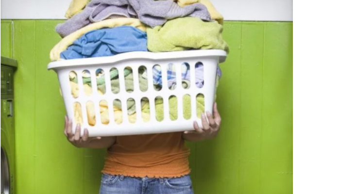 Someone carrying basket full of dirty clothes