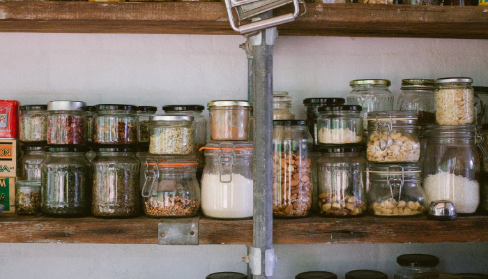 Picture of kitchen cupboards with goods in reusable glass containers