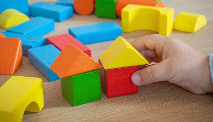 Picture of toy blocks with a hand