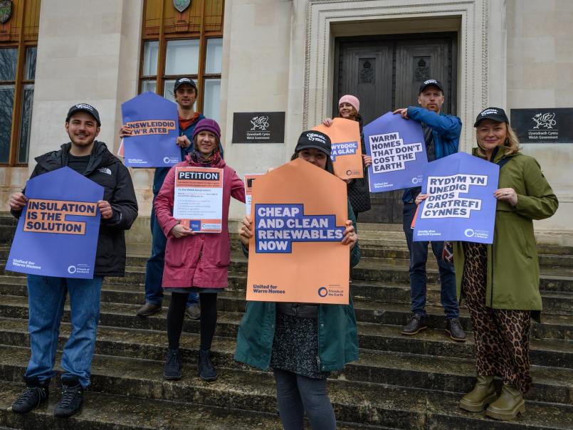 Campaigners holding placards on steps
