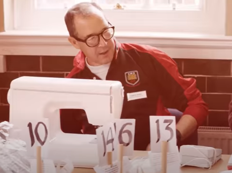 Man repairing clothes at a repair cafe