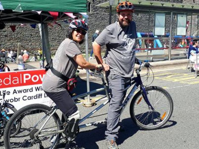 Two people on a tandem bike