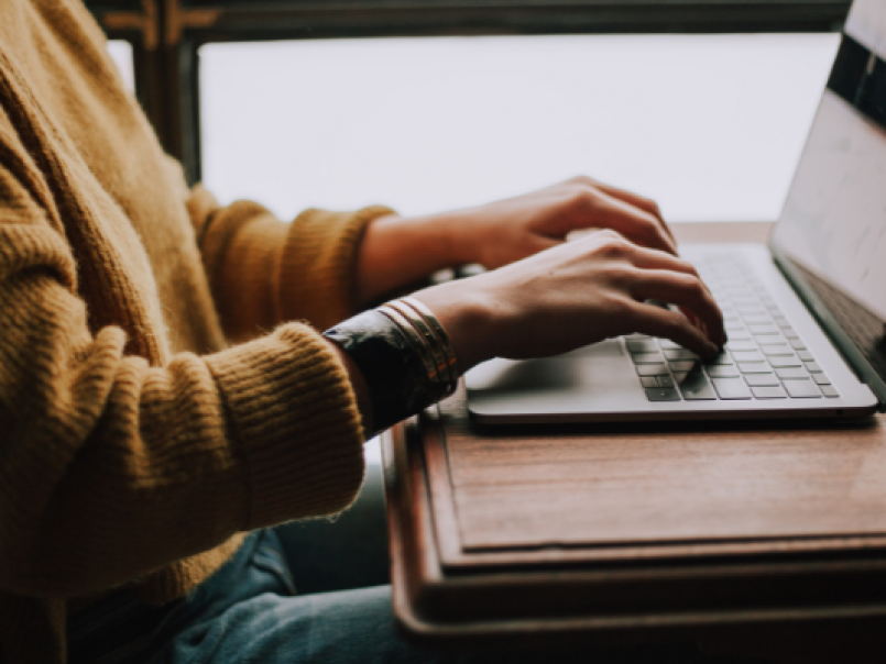Someone typing at a laptop
