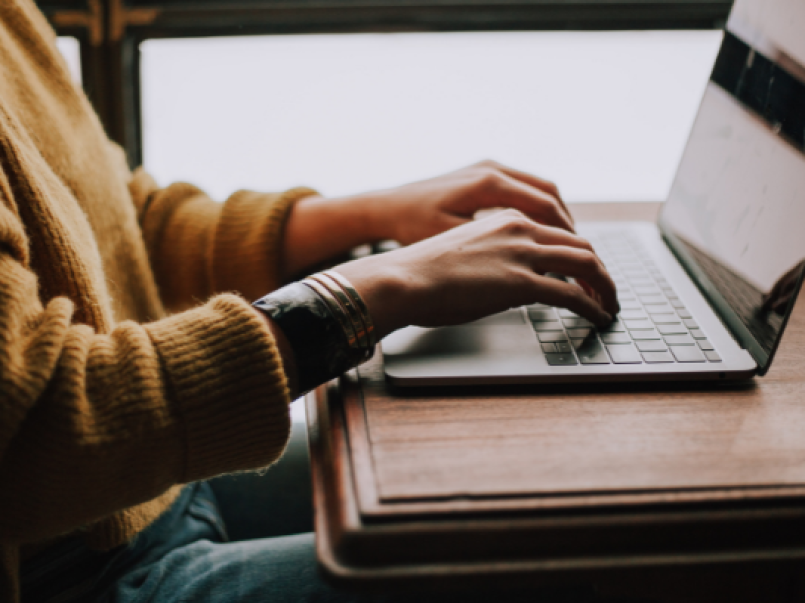 Someone typing at a laptop