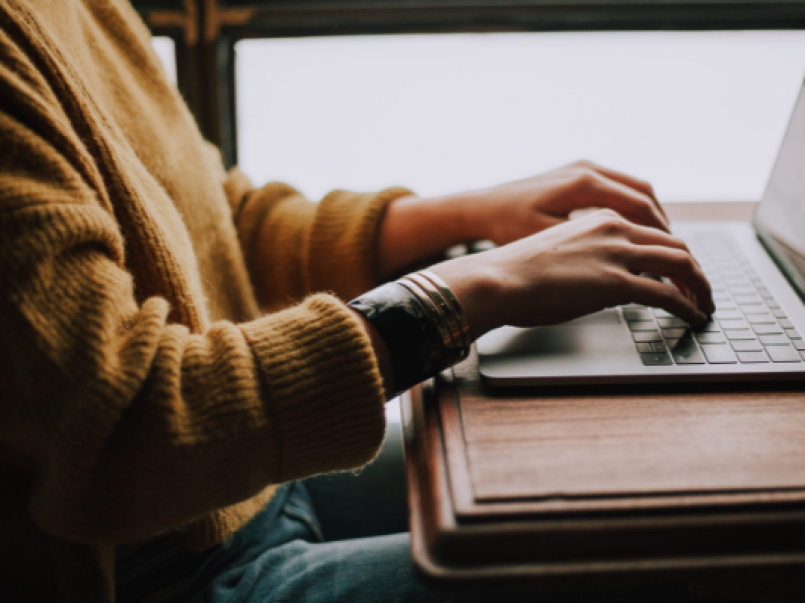 Someone typing at a laptop