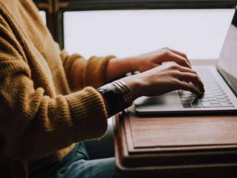 Someone typing at a laptop