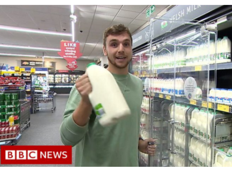 Man standing by a supermarket fridge