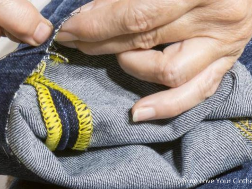 Someone mending jeans