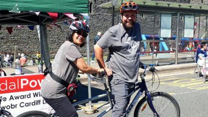 Two people on a tandem bike